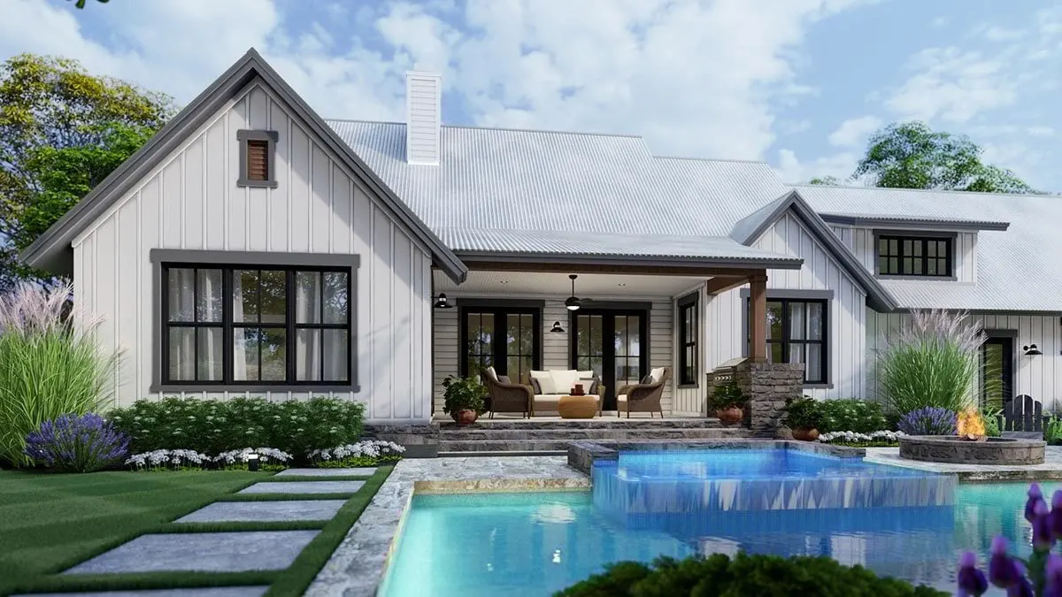 A stunning rear picture of the farmhouse with the French doors and windows is shown.