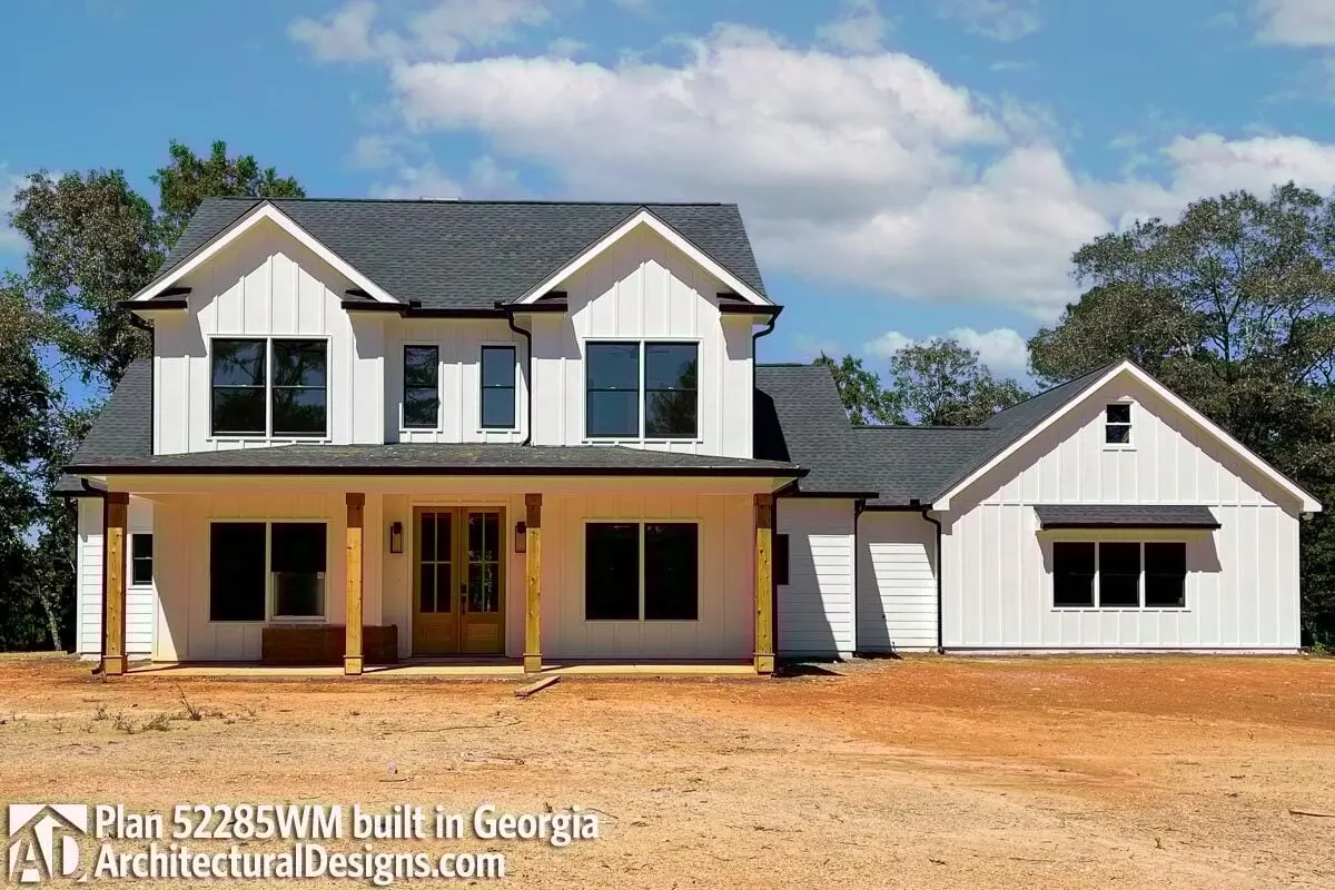 View of a traditional country farmhouse, with the French door and wood accent pillars.