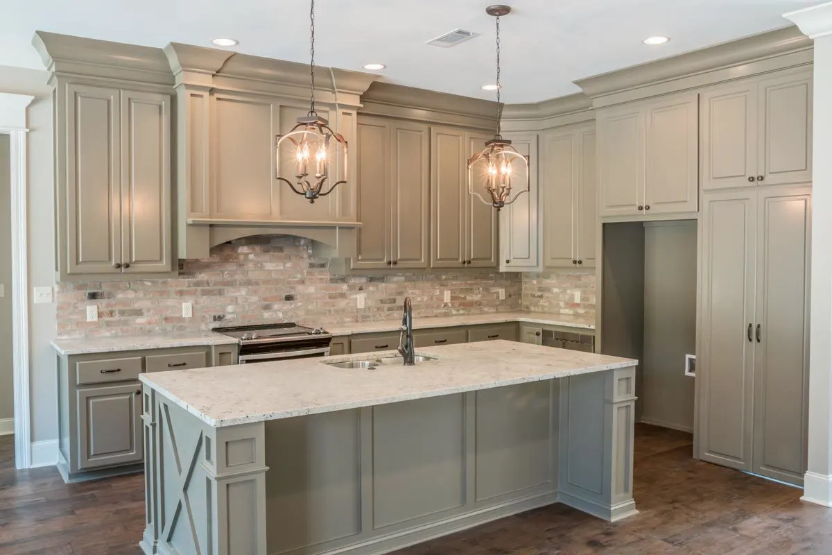The design of the kitchen, with a large walk-in pantry for storage and a central island.