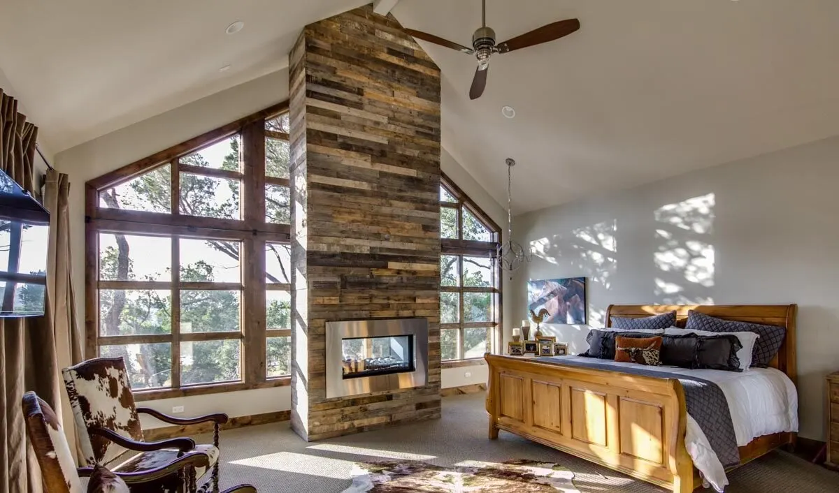 A glass wall window in the bedroom and a wood-burning stove.