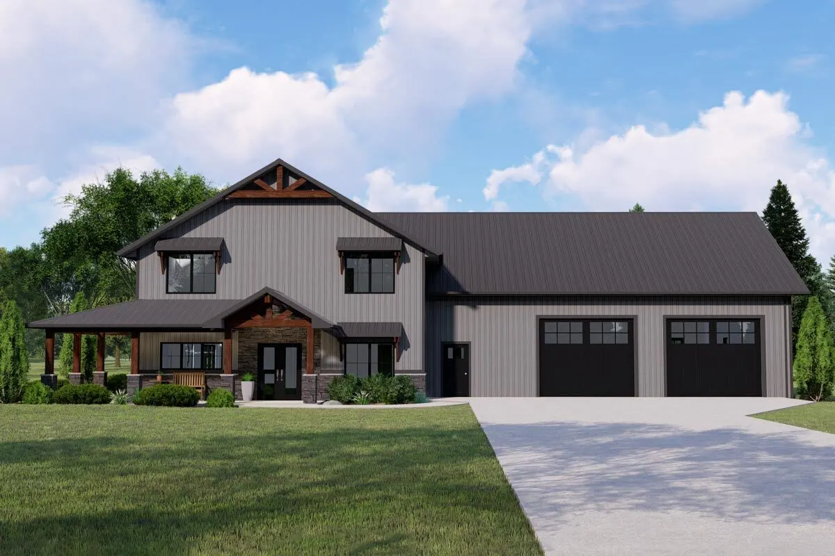 Stunning barndominium with a deep shade of color that highlights the porch's wooden accents and a sizable driveway.