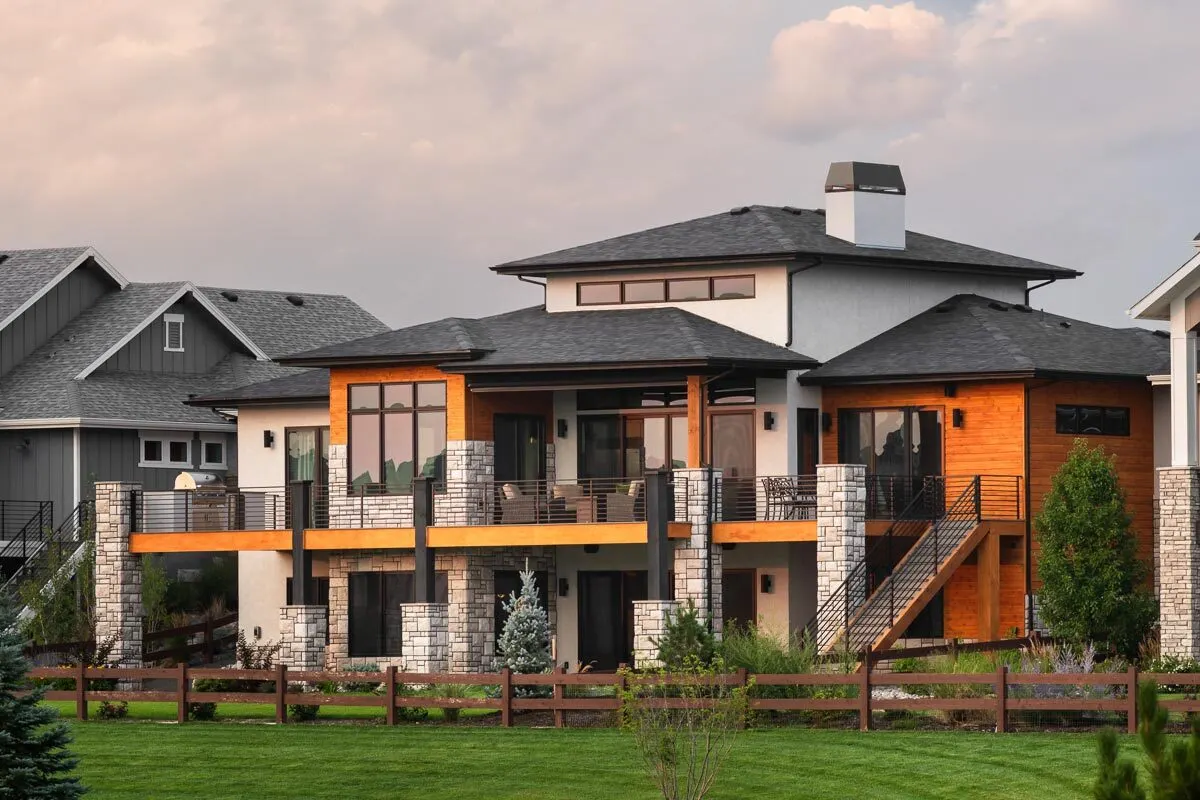 Amazing architectural deck design with wooden fencing at the rear of the home.