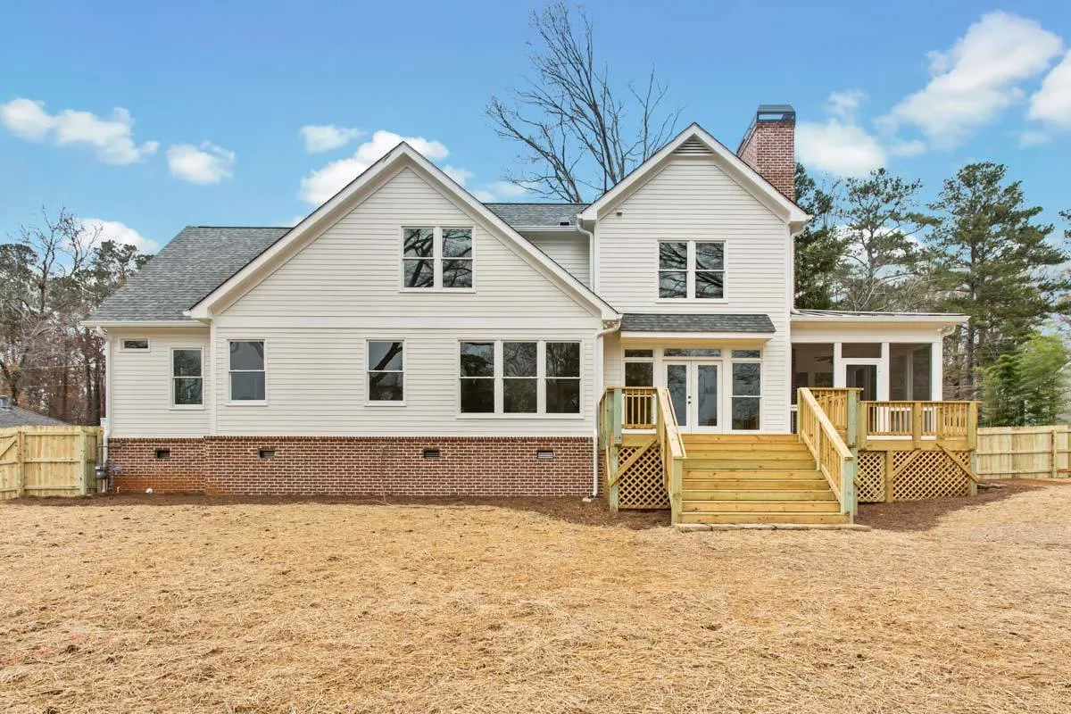 The home's exterior is composed of white horizontal siding and red bricks.