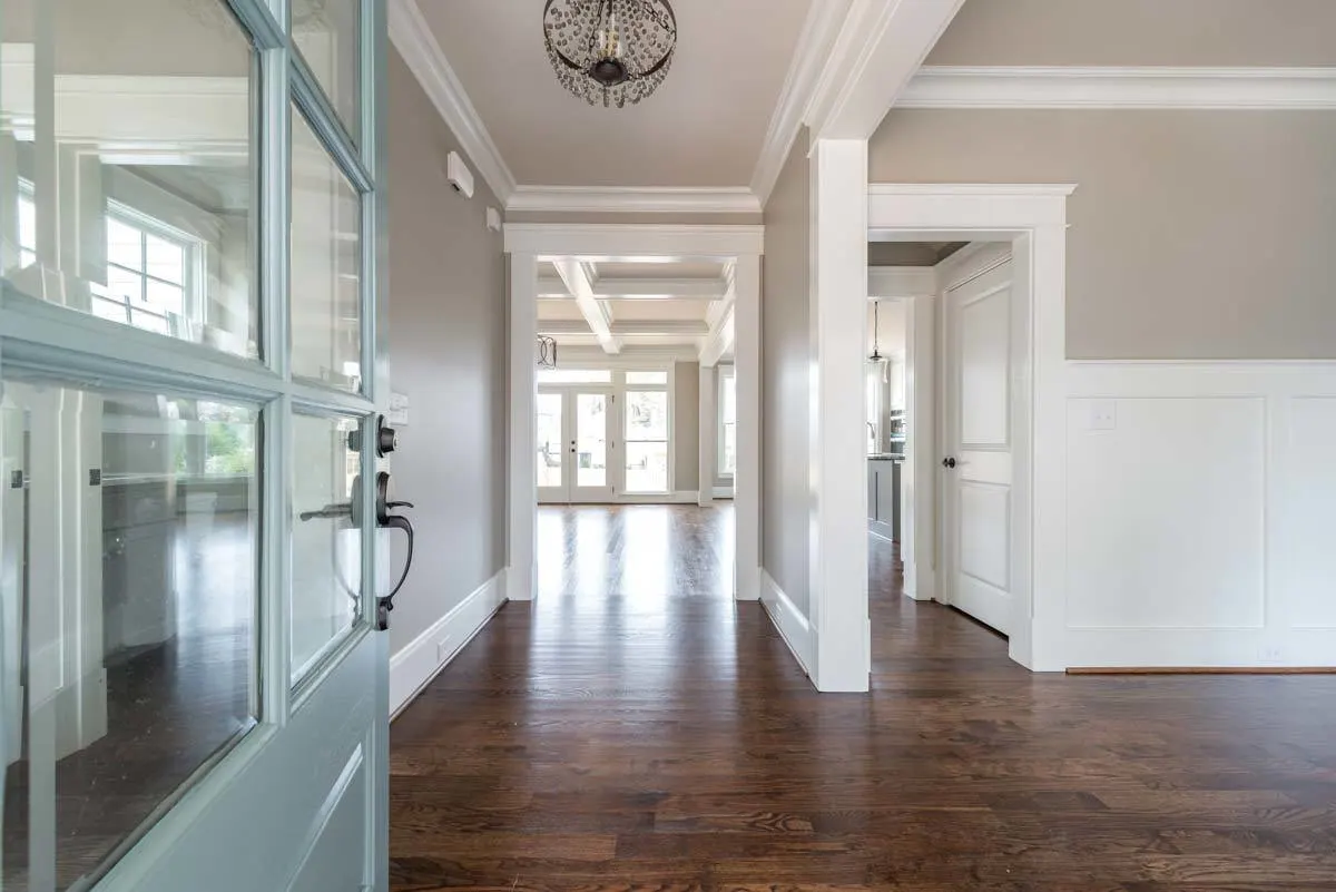A picture of the interior of the home with its white interior and hardwood accent flooring.