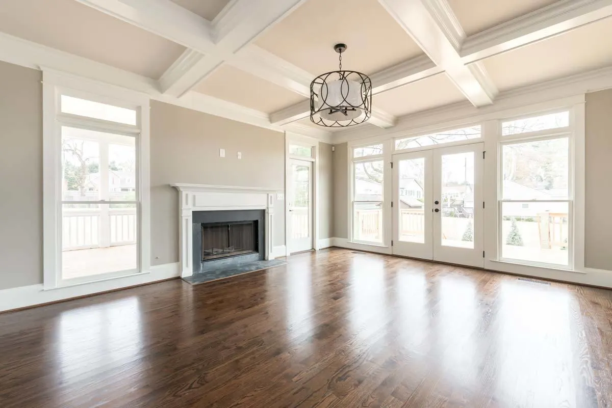 With an entrance to the screened porch area next to the fireplace are lovely huge white doors.