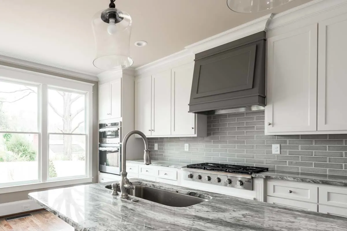 Cabinetry and modern kitchen appliances are placed in the kitchen neatly.
