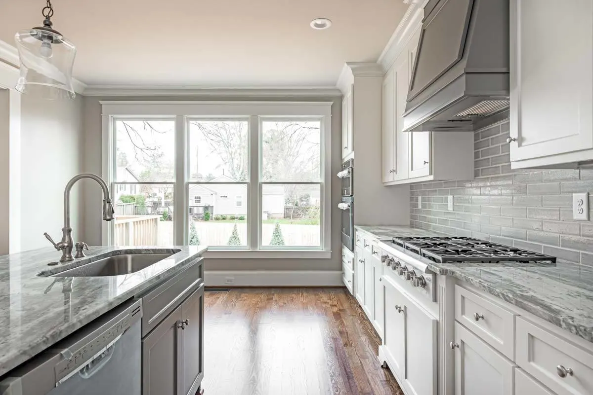 Through glass windows with white trim, you can get a lovely view of the outside.