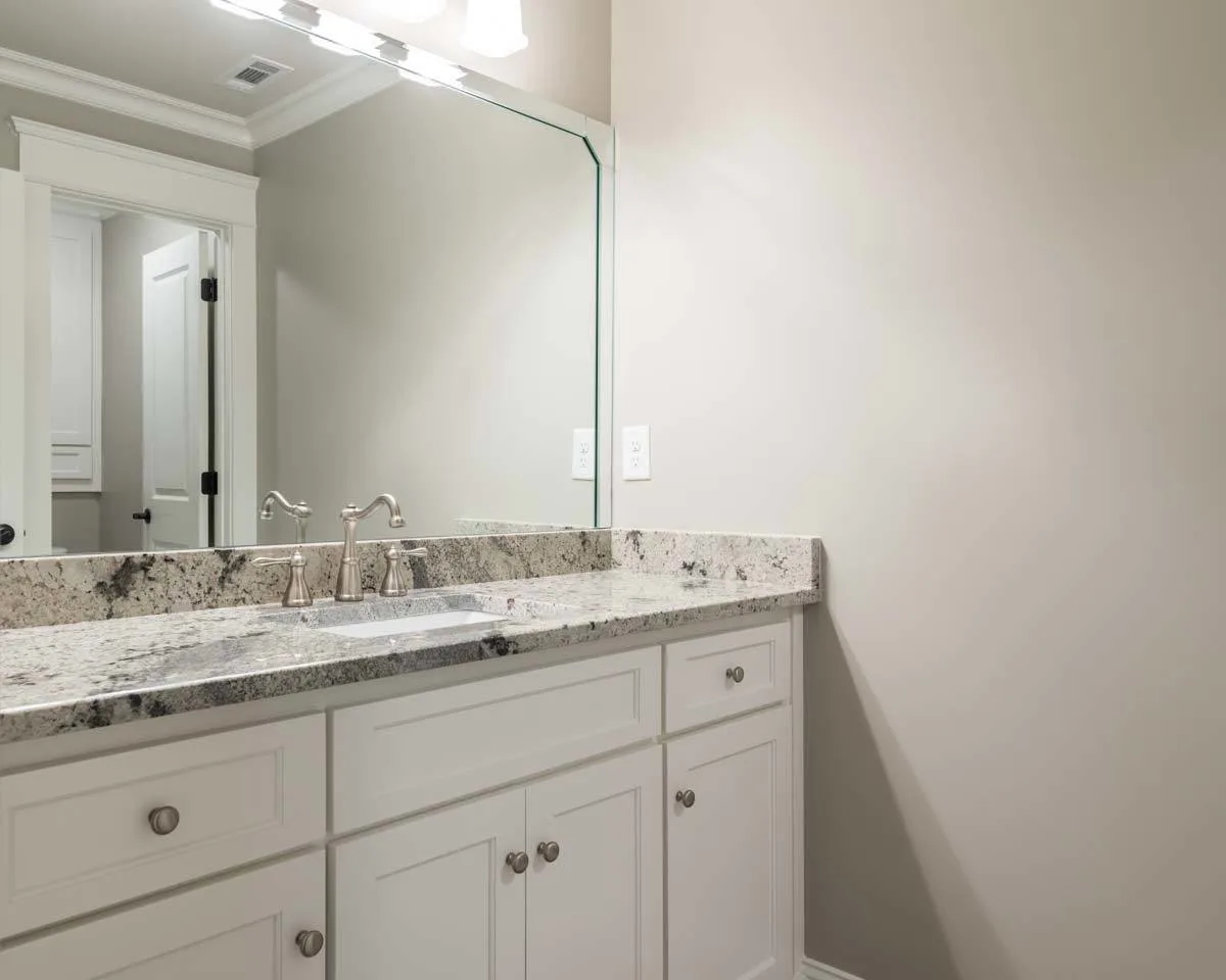 The vanity has a gorgeous counter made of marble with an earthy hue.