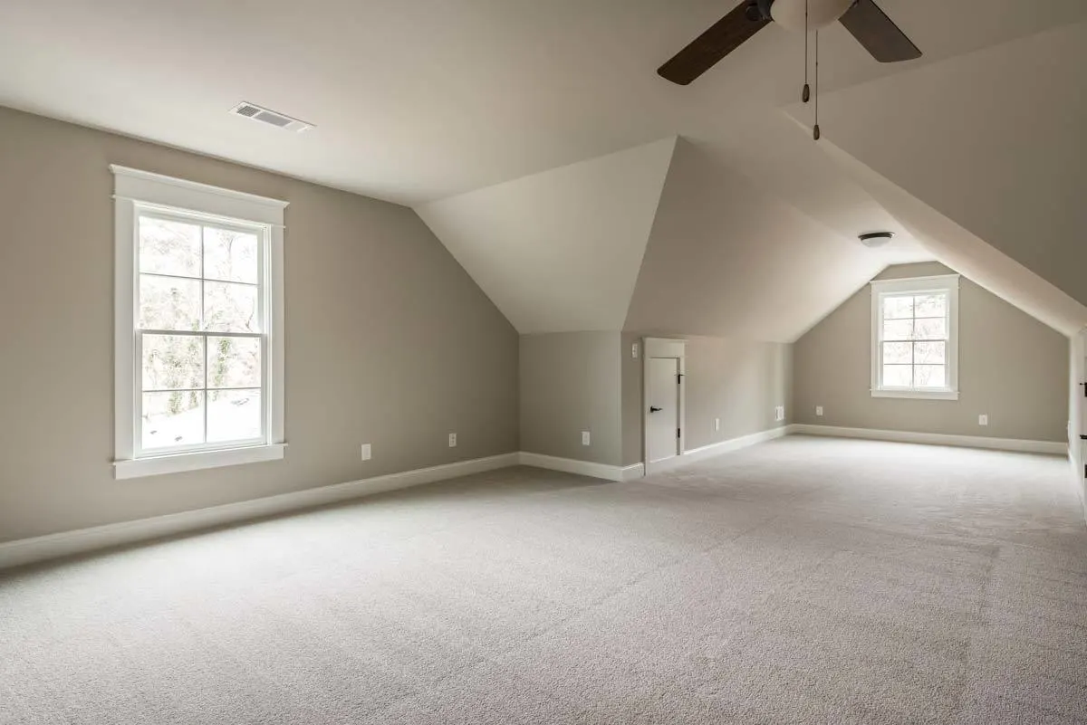 Fully carpeted optional bedroom in the beige color interior.
