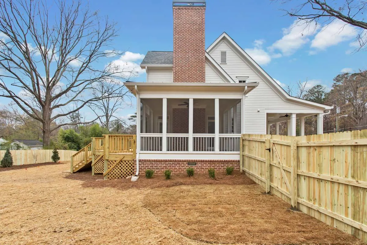 The big red brick frame of the fireplace stands out on the exterior.