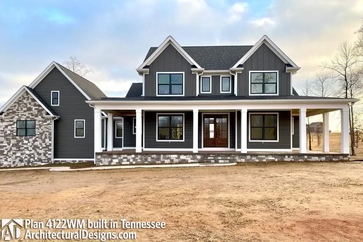 A modernized with an exquisite design, symmetrical framed glass windows, and an elevated main entry porch in a classic farmhouse.