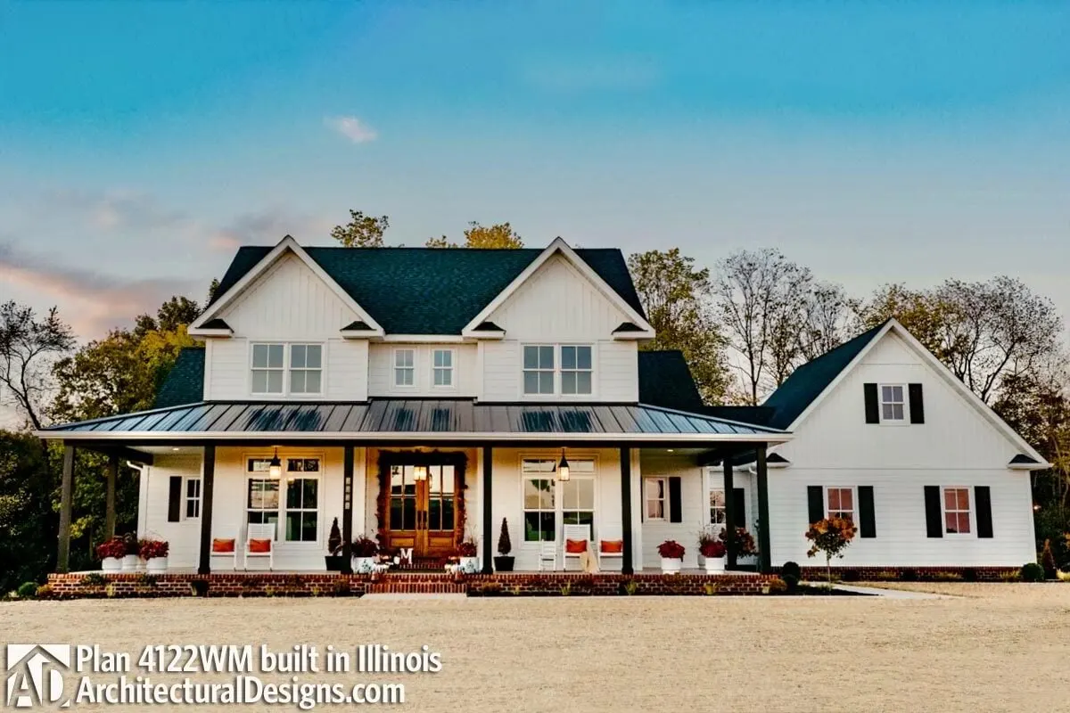 A more close look a the farmhouse features the main entrance porch and symmetrical framed windows.