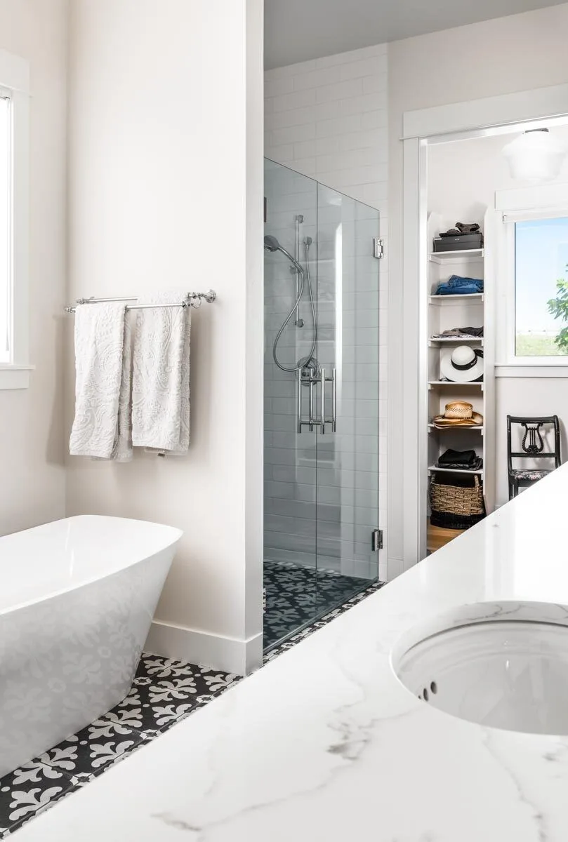 The bathroom is fully furnished with a bathtub, shower glass area, and sink.