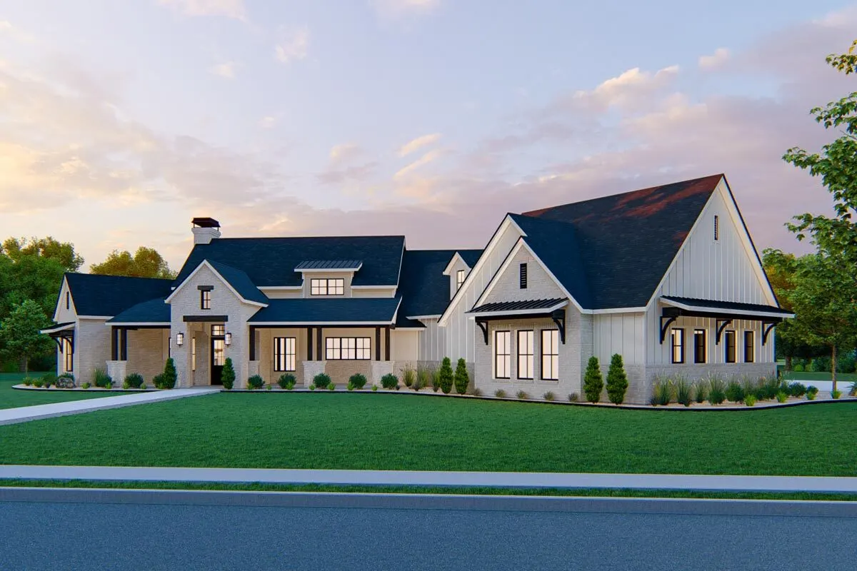 From the road, you can see the finely constructed modern farmhouse that is surrounded by greenery.