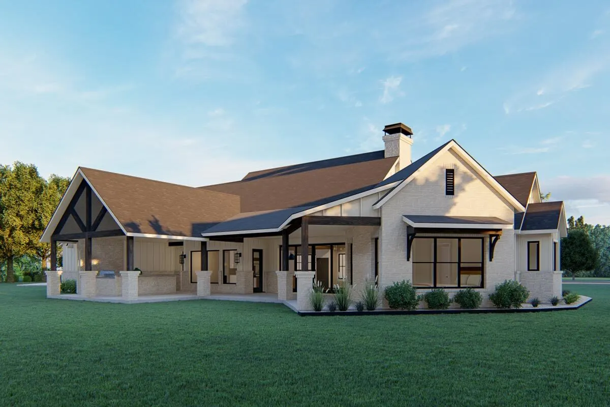 The use of stone columns and pillars gives the farmhouse's side view a beautiful appearance.