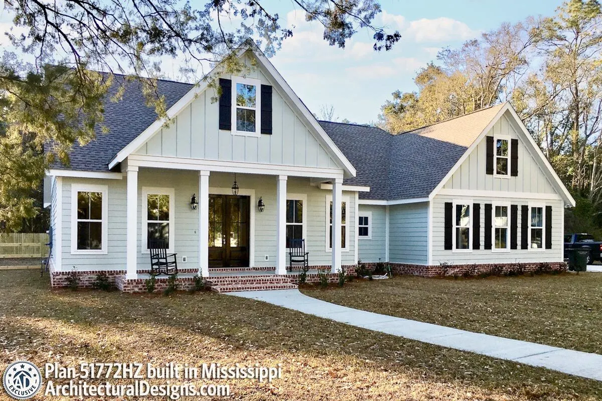The beautiful farmhouse with a bonus vaulted side room with beautiful framed windows and a stone walkway.