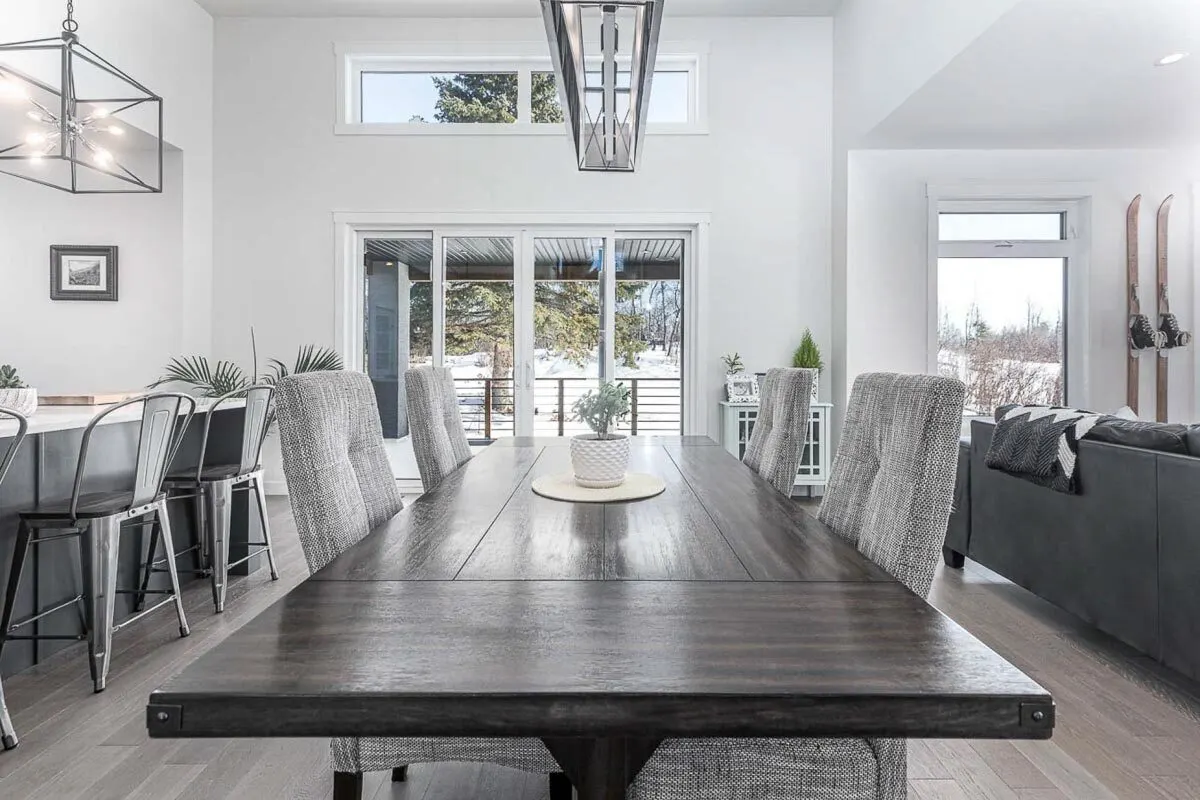 Black dining table with cozy gray chairs.