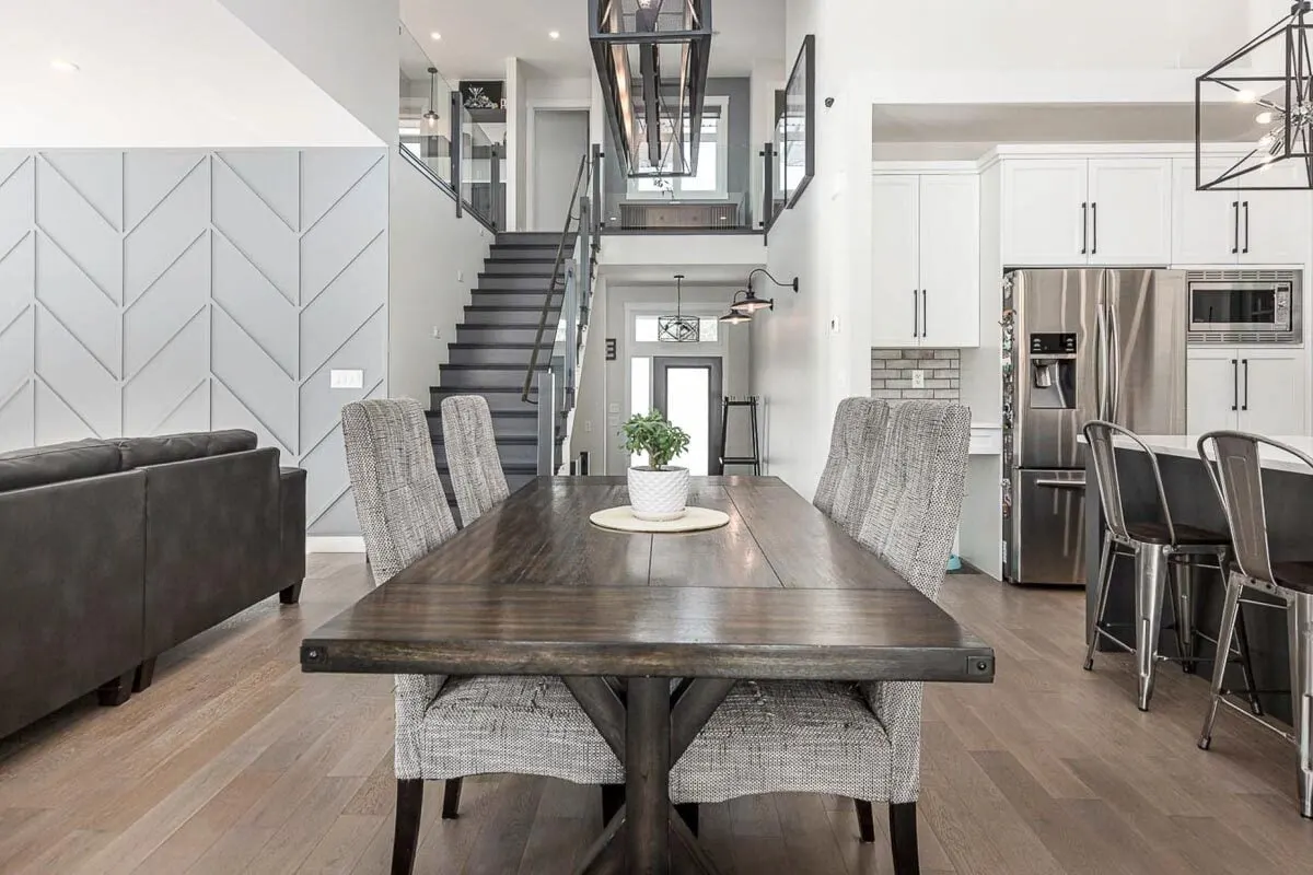 There is a staircase with a black color scheme that leads up to the upper family room area.