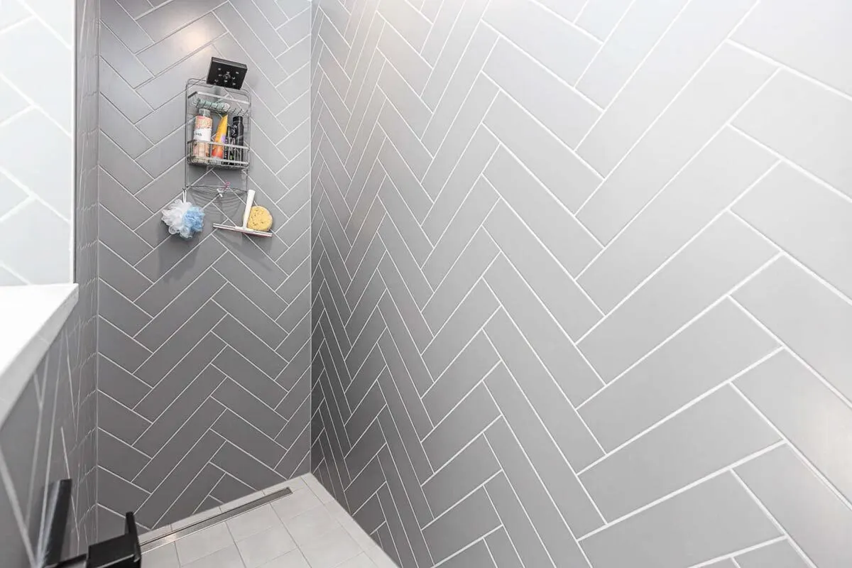 A shower area's gorgeous gray pattern tile wall.