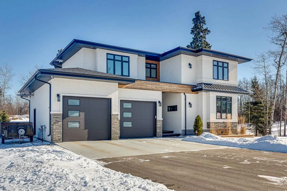 A wide driveway and a two-door garage are located on the left side of the home.