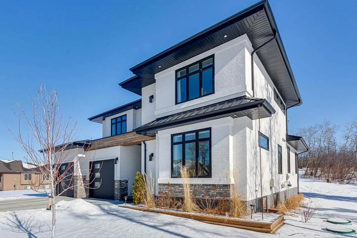 A glass window on the right side of the home with a black frame complements the white-painted walls.