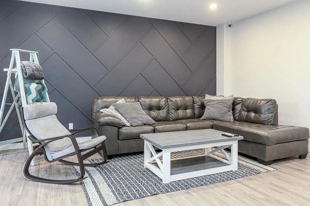 Leathered sofa in dark tone color with a rocking gray chair matches the center table.