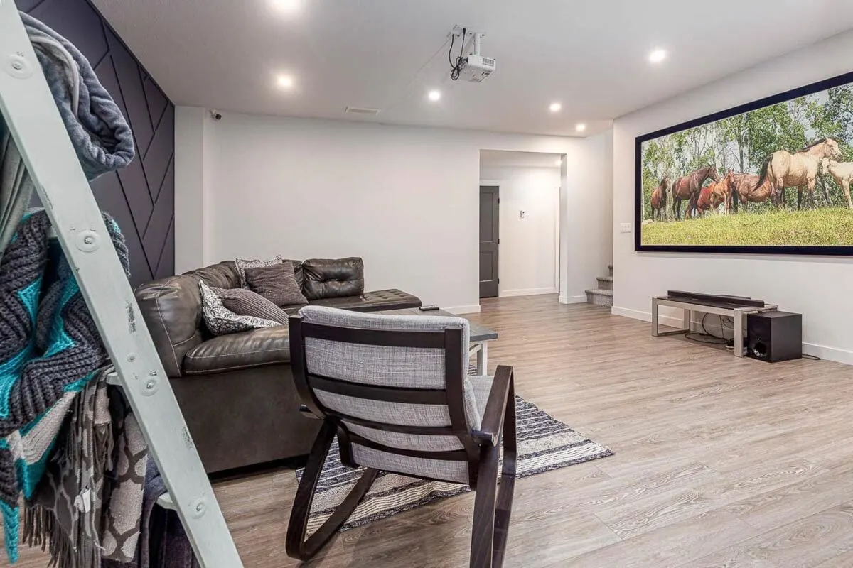 The family room space is brought to life by a large painted décor wall.