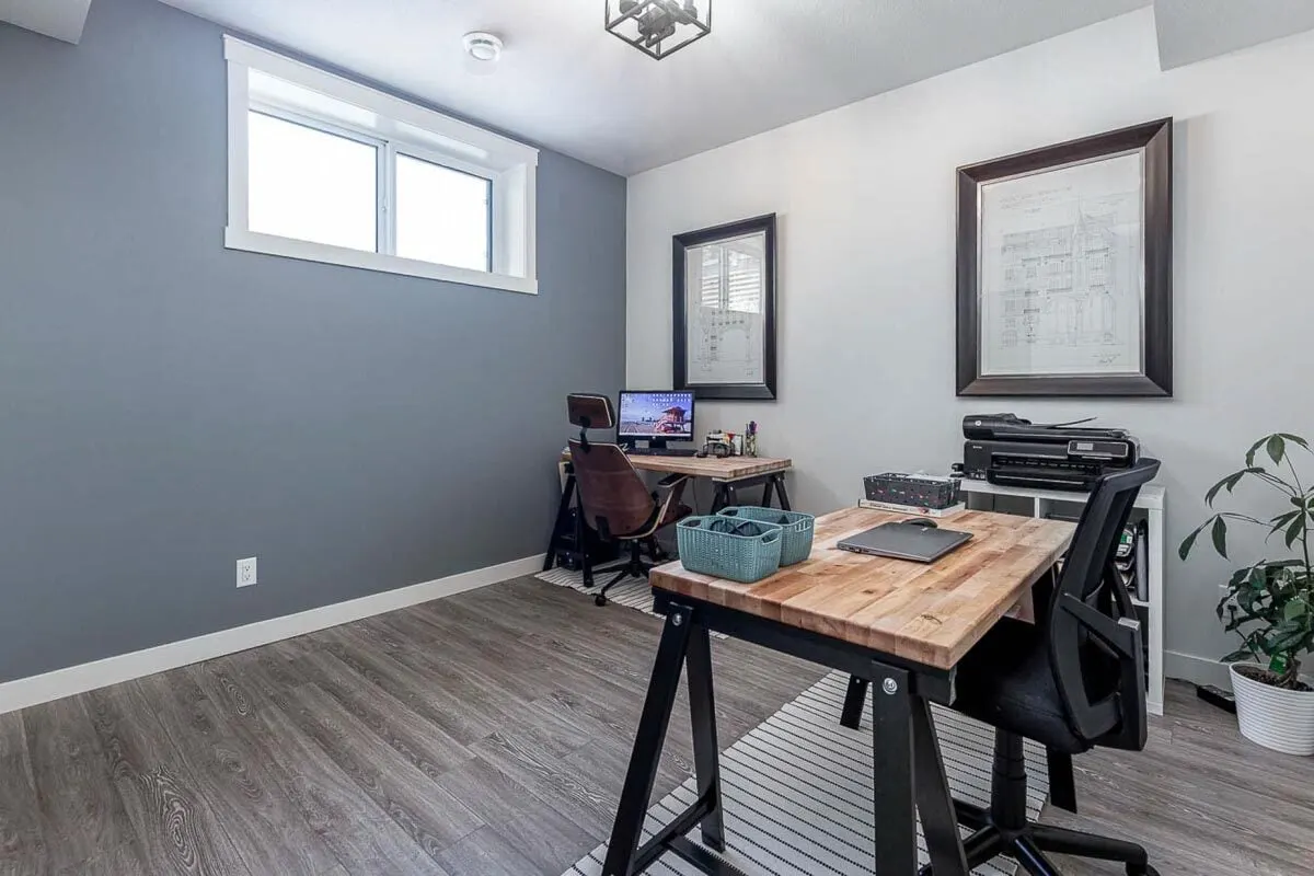 Mechanical space with two workstations and a sizable printer.