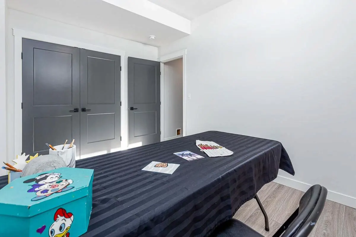 A room with a large art table is ideal for leisure activities.