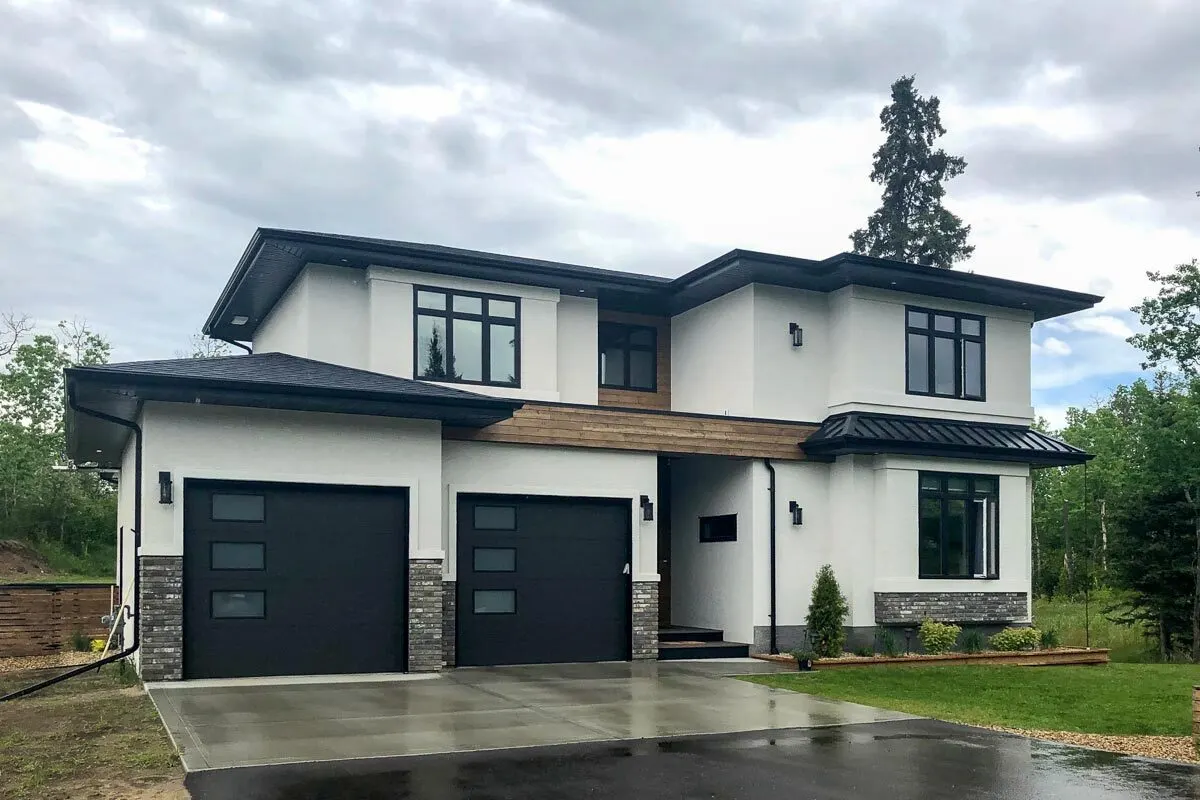 A large front yard with a wood fence in the back of the home.