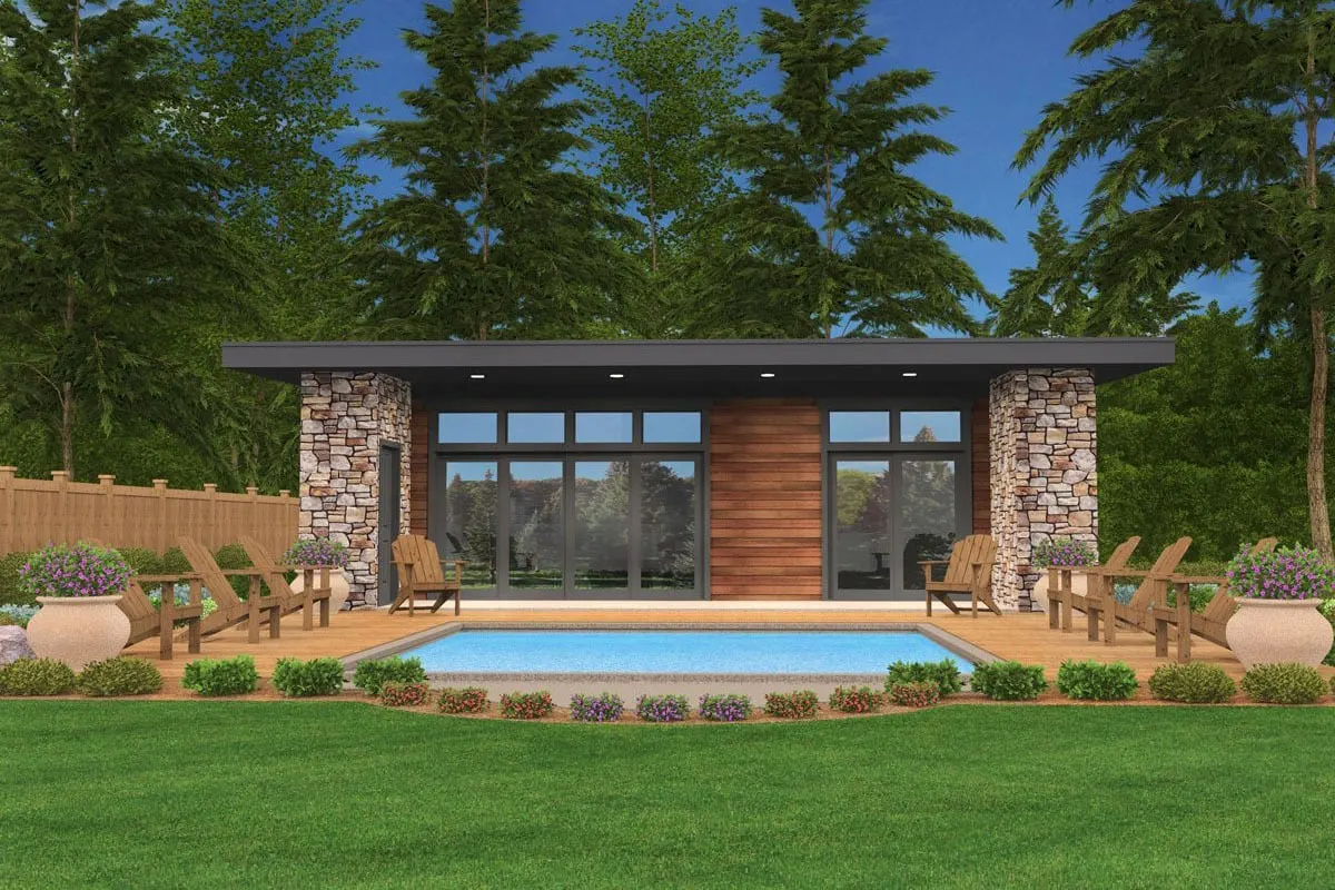 Image of the cottage's back area, centered with a pool and surrounded by lounge&nbsp;chairs made of wood.