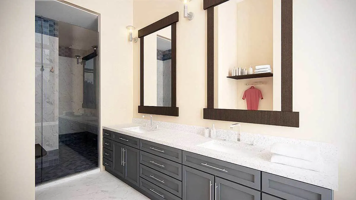 Vanities with a sleek gray frame and a white marble tabletop.