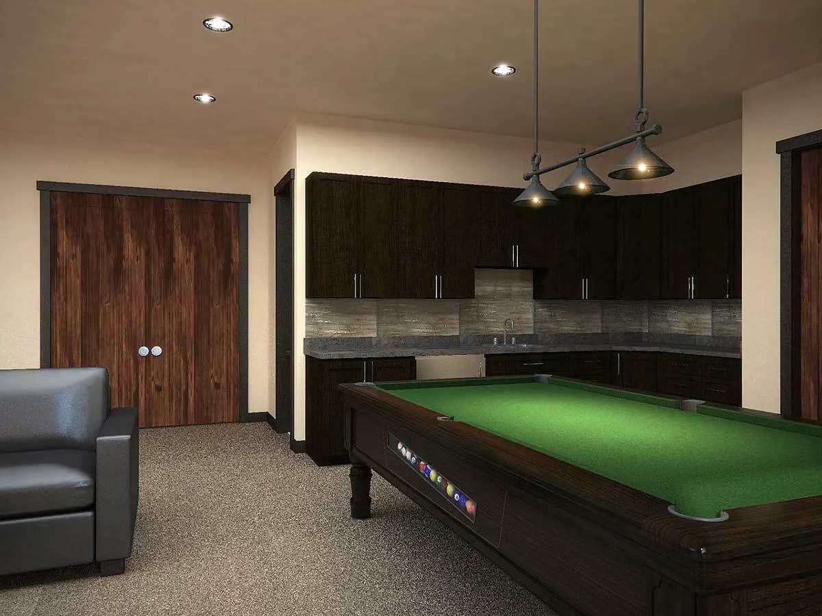 Lower level recreation room with bar kitchen and billiard table.