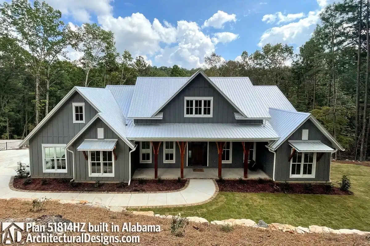 A farmhouse with a big, wide front yard was constructed in a gray tone design.