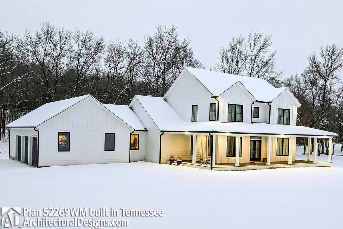 The scene of a country farmhouse in the snow is stunning.