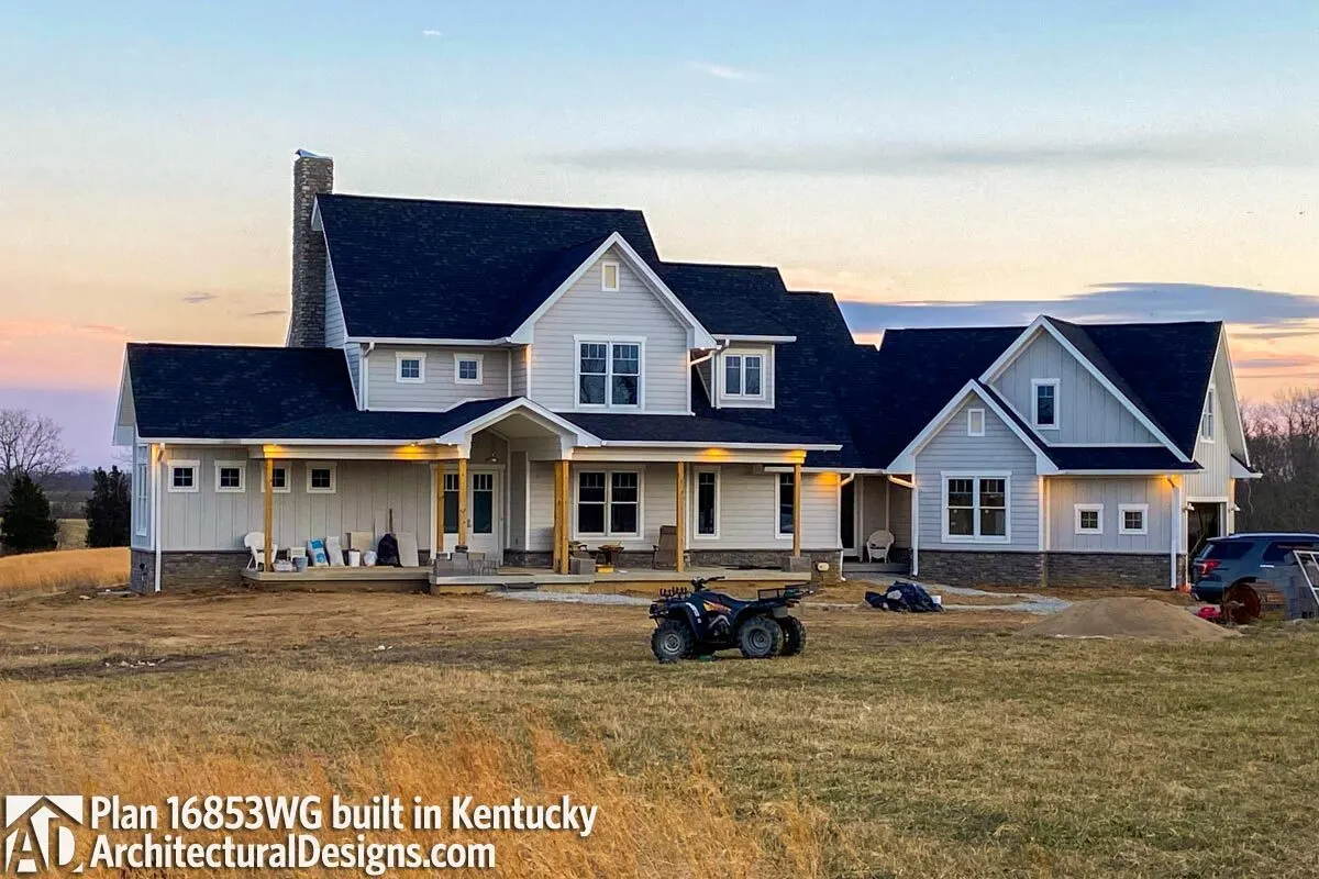 View of a farmhouse with an exquisite royal blue roof and a busy yard.