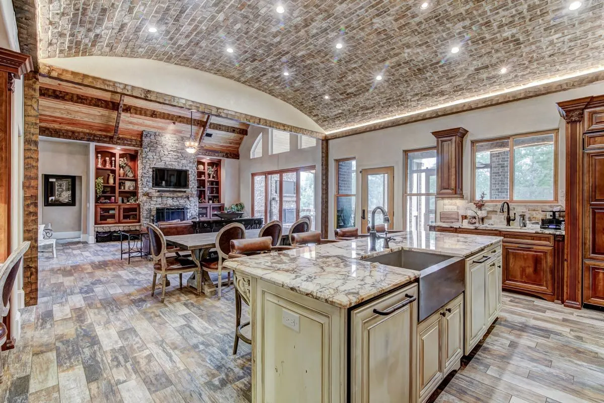A visible brick ceiling design and a bright tone shade center island.
