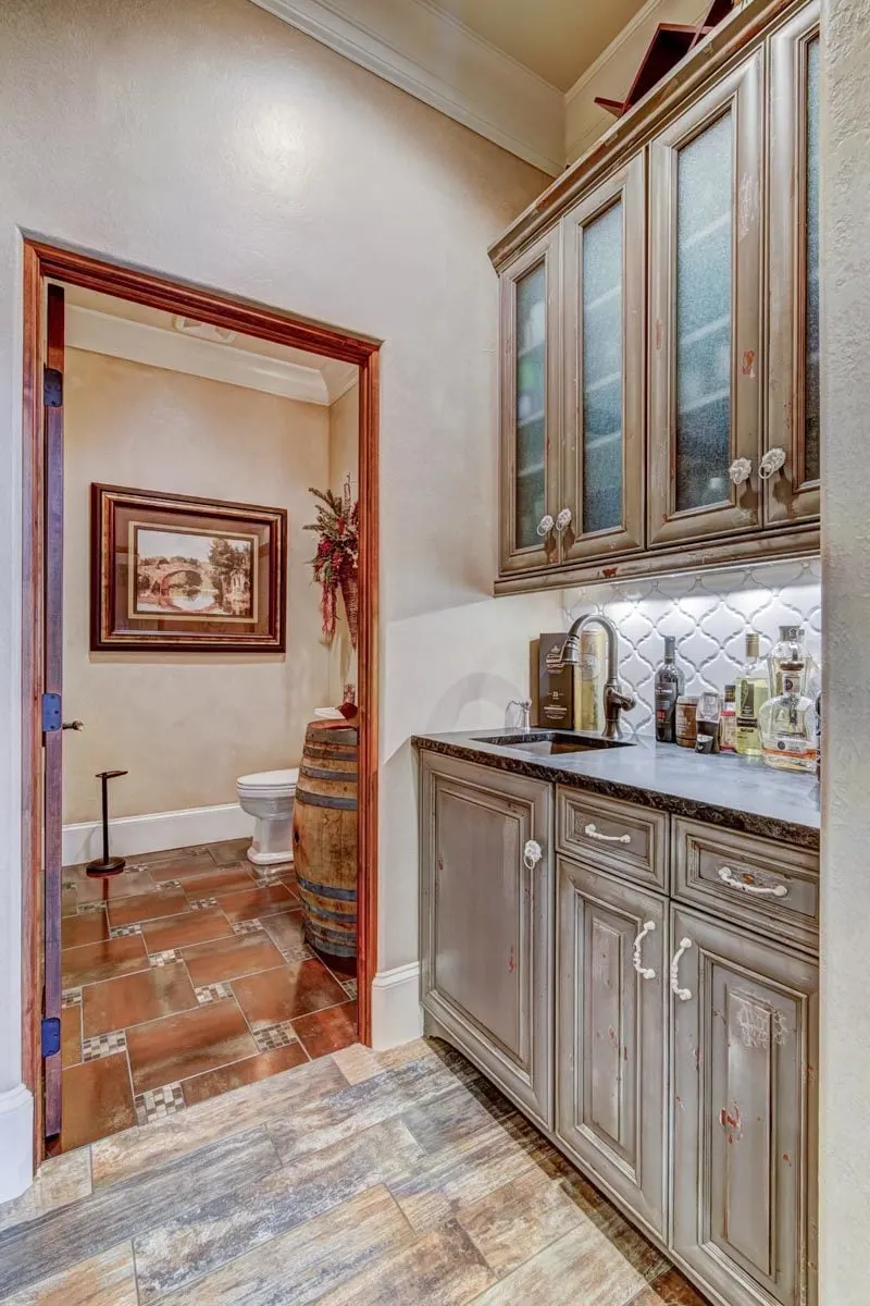 Powder room area with a nearby liquor pantry.
