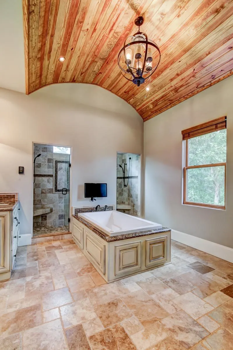 Two shower sections and a soaking tub in the middle of the master bathroom.