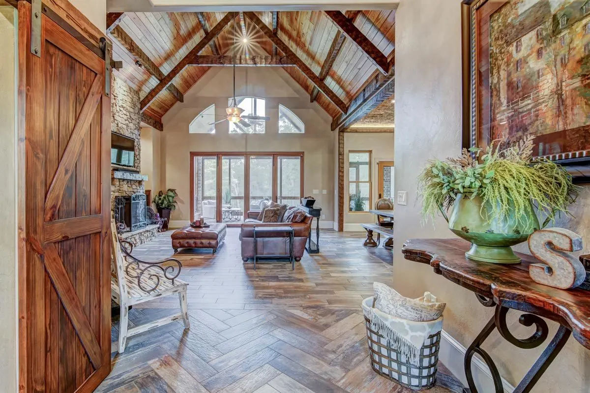 View of the living room from the entrance in a wooden vintage accent design interior.