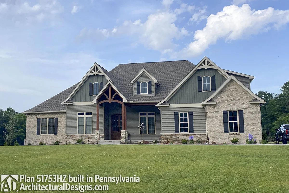 A remarkable external style with a dark gray roof and siding and noticeable dark blue window shutters.