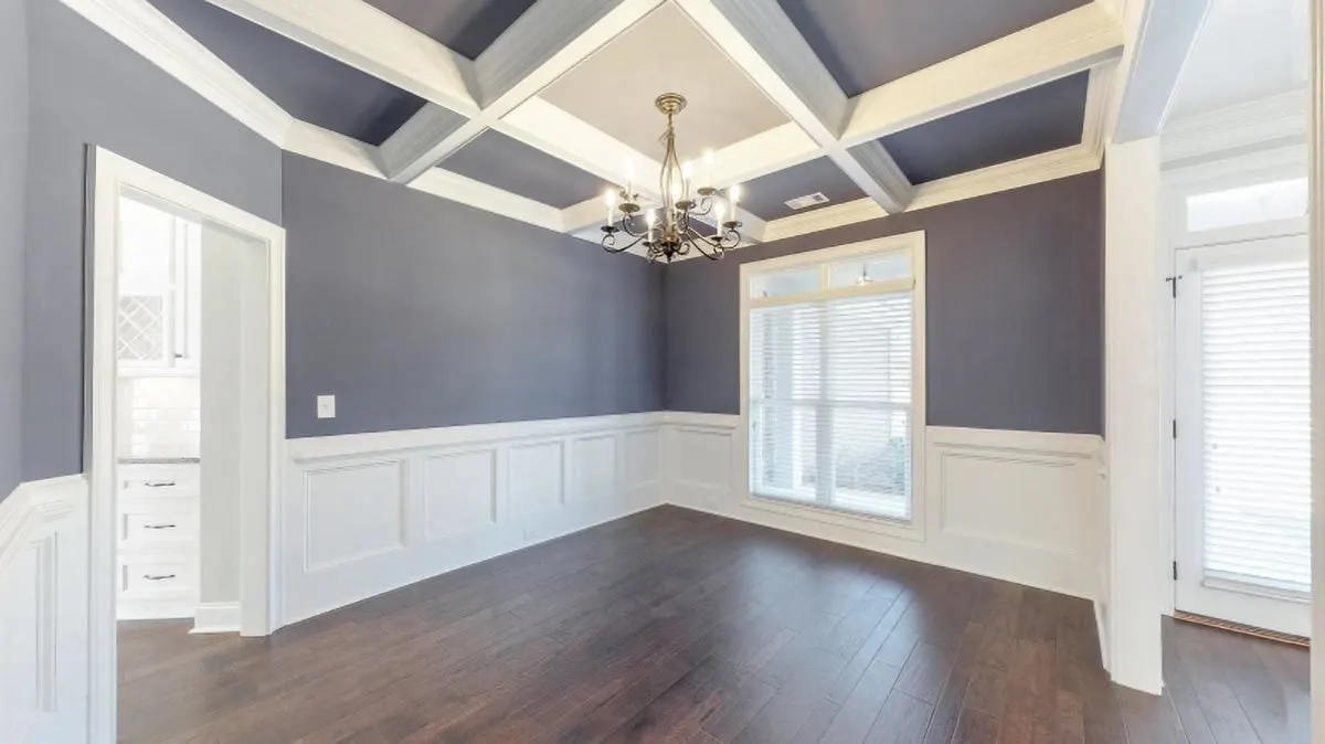 The space looks great with a trendy ceiling structure and a stunning chandelier as the centerpiece.