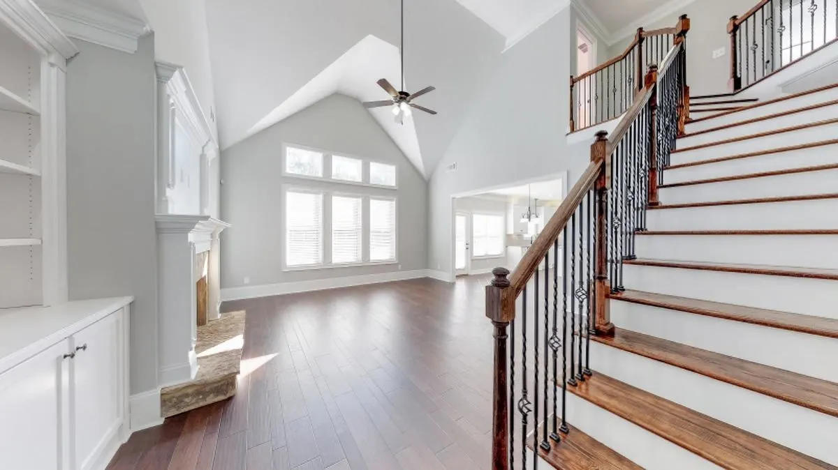 The home's entryway has a nearby stairway leading up to the second story.