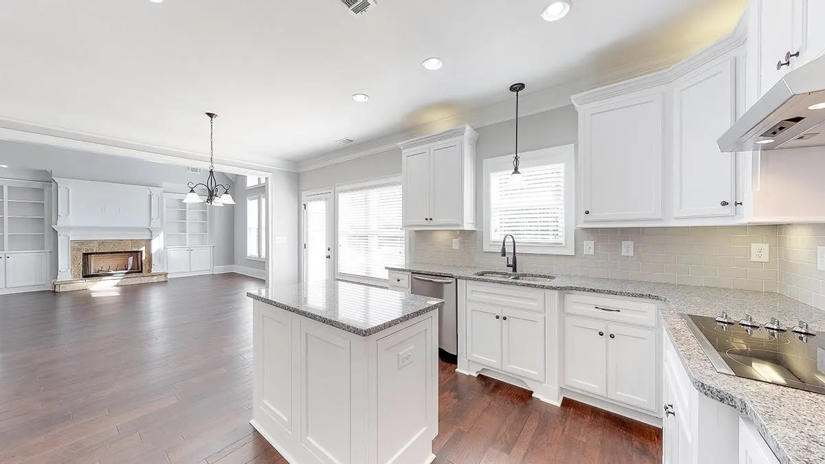 The modern minimalist kitchen and the white-gray marble countertop go nicely together.