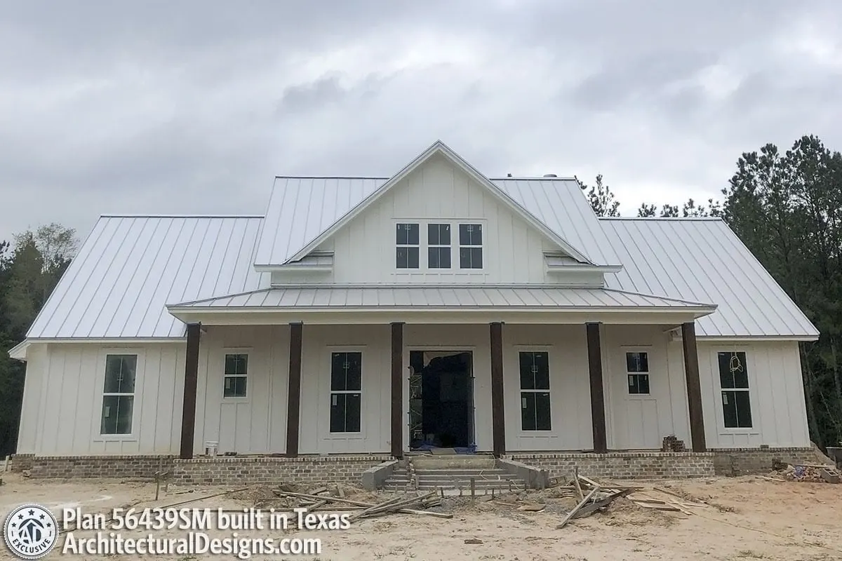 Farmhouse that is unfinished and has a white accent color.