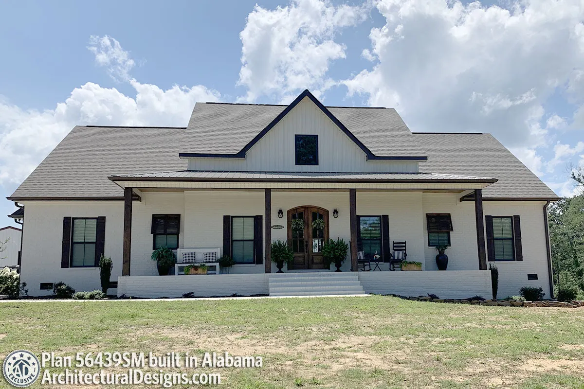 The porch and steps of the modern farmhouse provide a stunning visual impact.