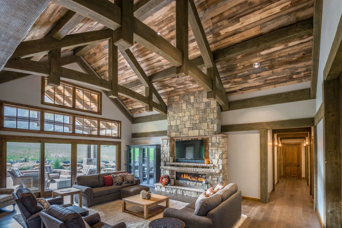 The living room is magnificent, with an exposed wooden beam ceiling and a large fireplace.