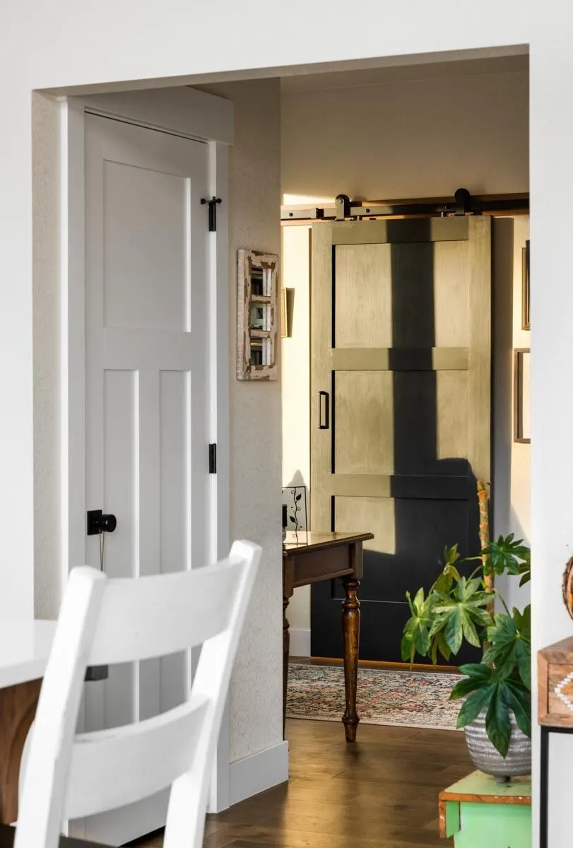 Access to the home office space via a black barn-style door.