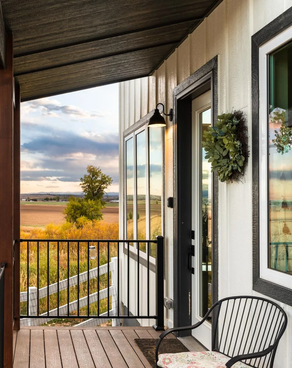 The outside black trim on the door and windows matches the deck railings.