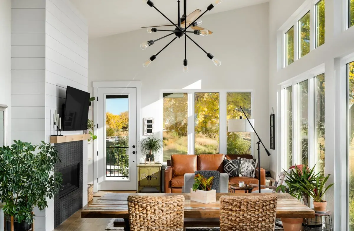 The living room section has a high ceiling and interior white paint.